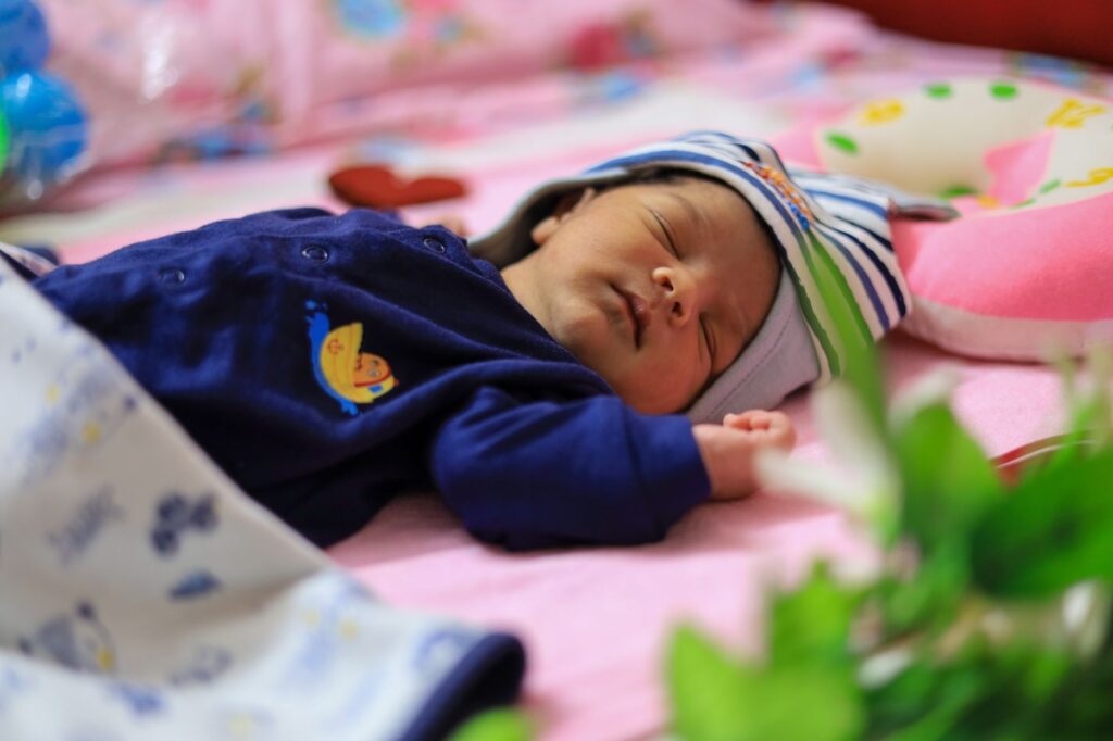 A peaceful sleeping baby with a humidifier in the background